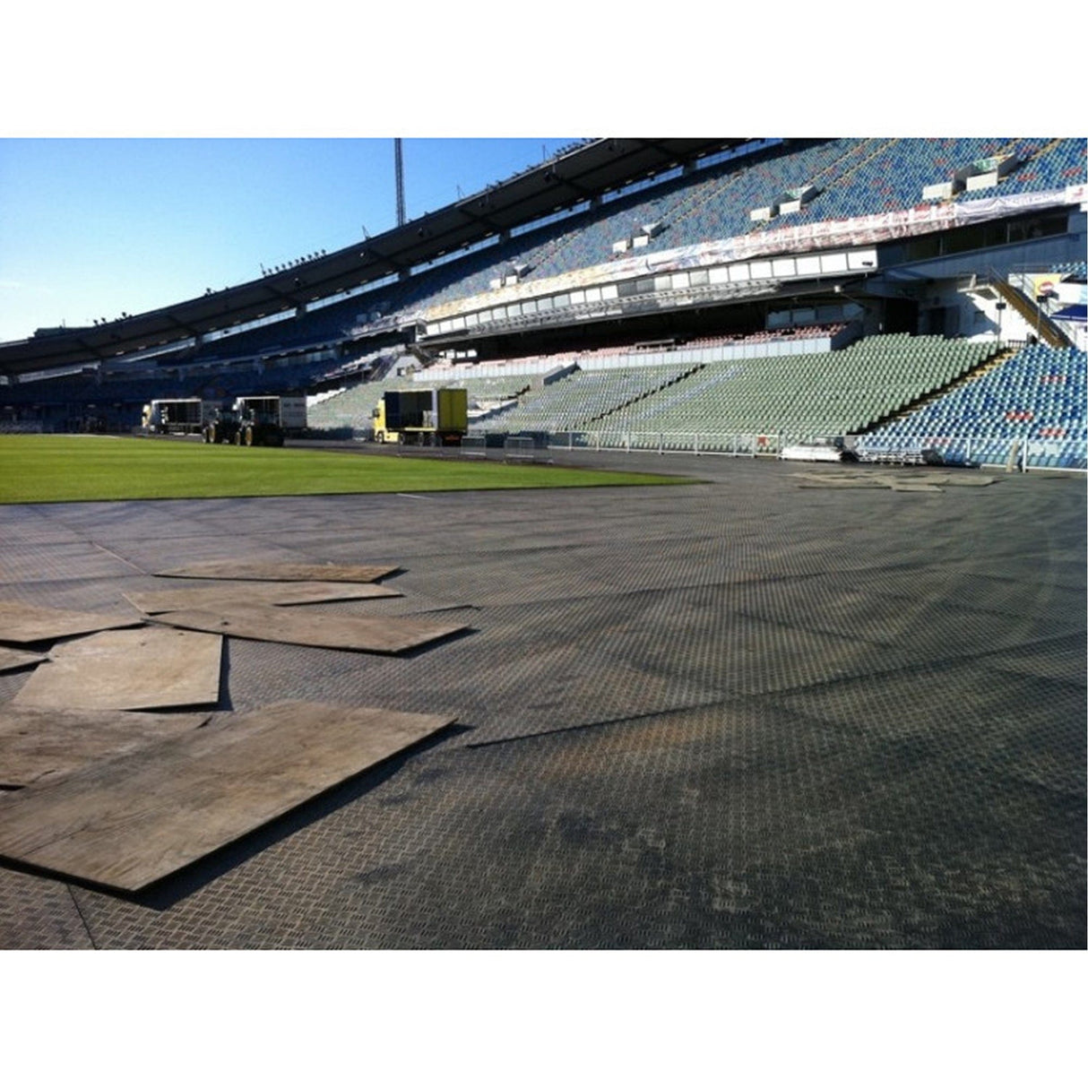Ground protection access mats laid across a stadium pitch for temporary access