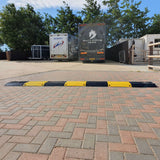 titan-steel-speed-ramp-bump-black-yellow-parking-lot-traffic-control-industrial-hgv-vehicle-suitable-heavy-duty-robust-durable-modular-high-visibility-road-low-profile-welded-metal-hot-dip-galvanised-reusable-cable-hose-ramp-shopping-centres-railway-waste-centres-low-maintenance 