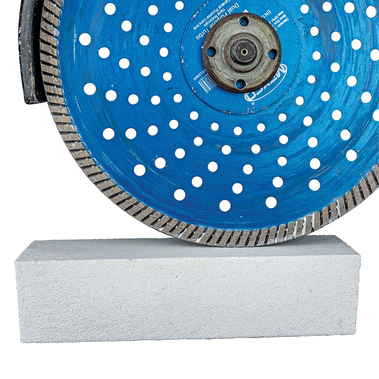 Mexco Diamond Sharpening Stone held against a rotating blue Mexco diamond blade, sharpening the cutting segments
