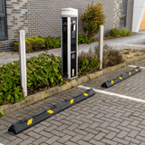 Car parking wheel stop in yellow and black in front of EV Charging bays