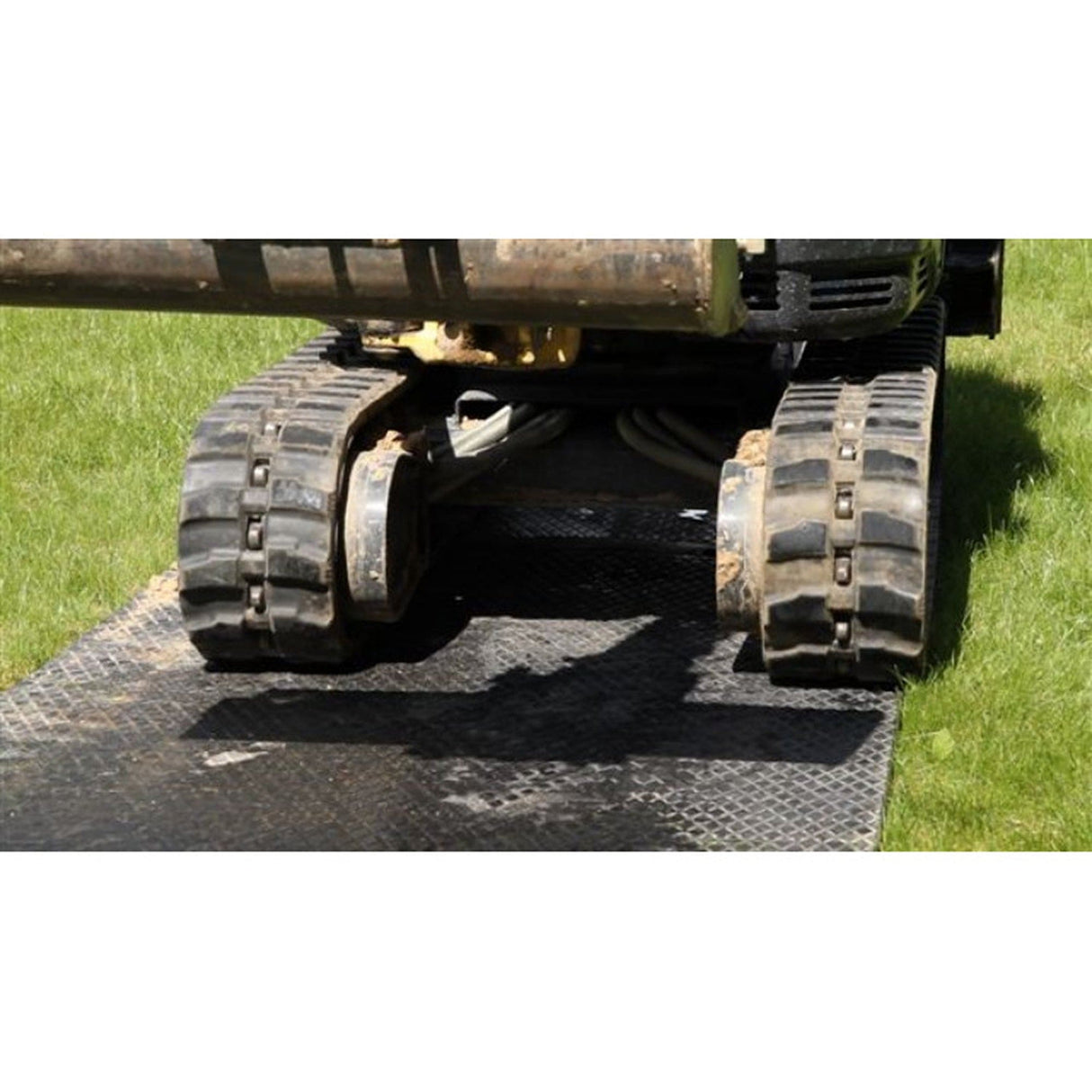 Tracked mini excavator's rubber tracks positioned on an EuroTrak access mat