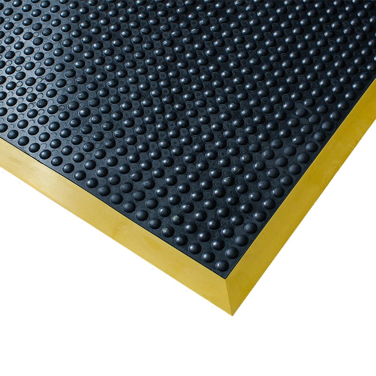 Ergotred anti-fatigue mat corner detail showing the domed black surface and bevelled yellow edge