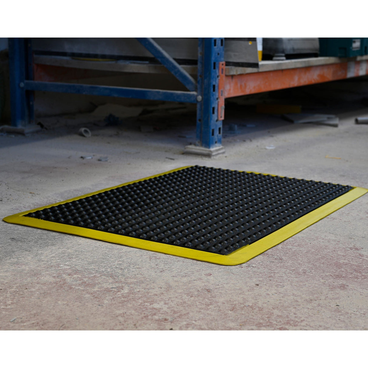 Workshop operator standing on an Ergotred anti-fatigue mat beside a CNC router