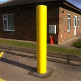 fixed-round-plain-yellow-bollard-crash-impact-high-anti-ram-vehicle-safety-perimeter-security-galvanised-steel-tested-heavy-duty-outdoor-street-furniture-pedestrian-modern-urban-public-space-carpark-building-protection-commercial-industrial