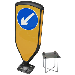 3SIXTY self-righting bollard, black frame with blue keep-left diagonal arrow face, shown with the foundation cage and gro