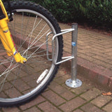 Durable cycle holder supports bicycle tyre, suitable for public use.